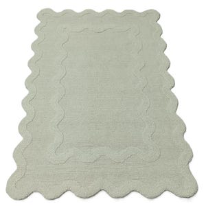 May include: A light green rectangular bath mat with a scalloped edge and a matching inner border. The mat is made of a soft, absorbent material, perfect for a bathroom. The design is simple yet elegant, adding a touch of sophistication to any bathroom decor.