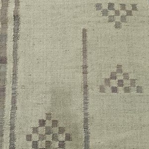 May include: A close-up of a beige rug with a woven pattern. The rug has a subtle geometric design in a darker shade of beige.