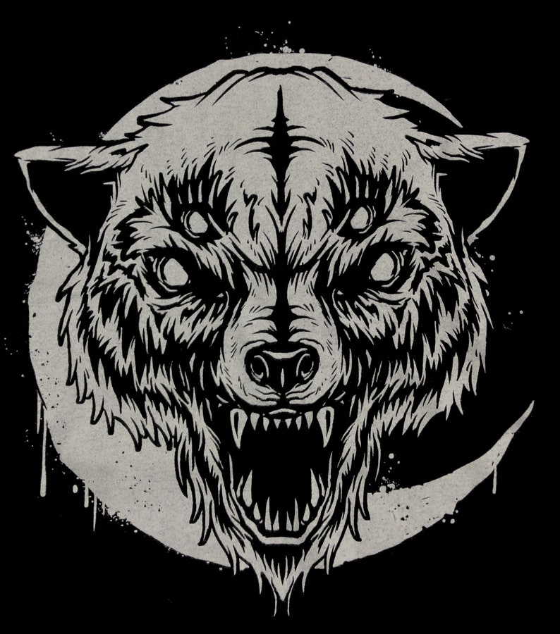 May include: A black and white illustration of a wolf's head with three eyes, a large mouth, and sharp teeth. The wolf's head is set against a background of a crescent moon with a grunge effect.