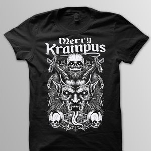 May include: Black t-shirt featuring a detailed white graphic of Krampus, a horned figure with a long tongue, surrounded by skulls and chains. The text "Merry Krampus" is displayed above the central image in a gothic font.