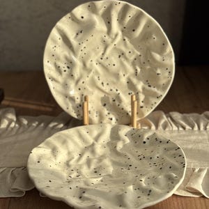 May include: A rustic wooden sign with the text "Welcome to our home" in white lettering. The sign features a distressed finish and a simple, inviting design, perfect for a front porch or entryway.