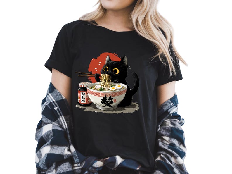 Woman wearing a T-shirt with a cute cartoon black cat eating ramen with chopsticks in front of a red sun background and soy sauce bottle.