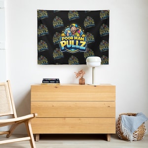 May include: Black tapestry with the text "POOR MAN PULLZ" repeated across the surface. The center features a logo with a cartoon character holding cards. The tapestry is hanging above a wooden dresser.