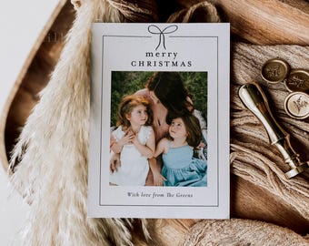 May include: A Christmas card with a family photo, featuring the text "merry CHRISTMAS" and "With love from The Greens". The card is accompanied by gold wax seals and a gold wax stamp.