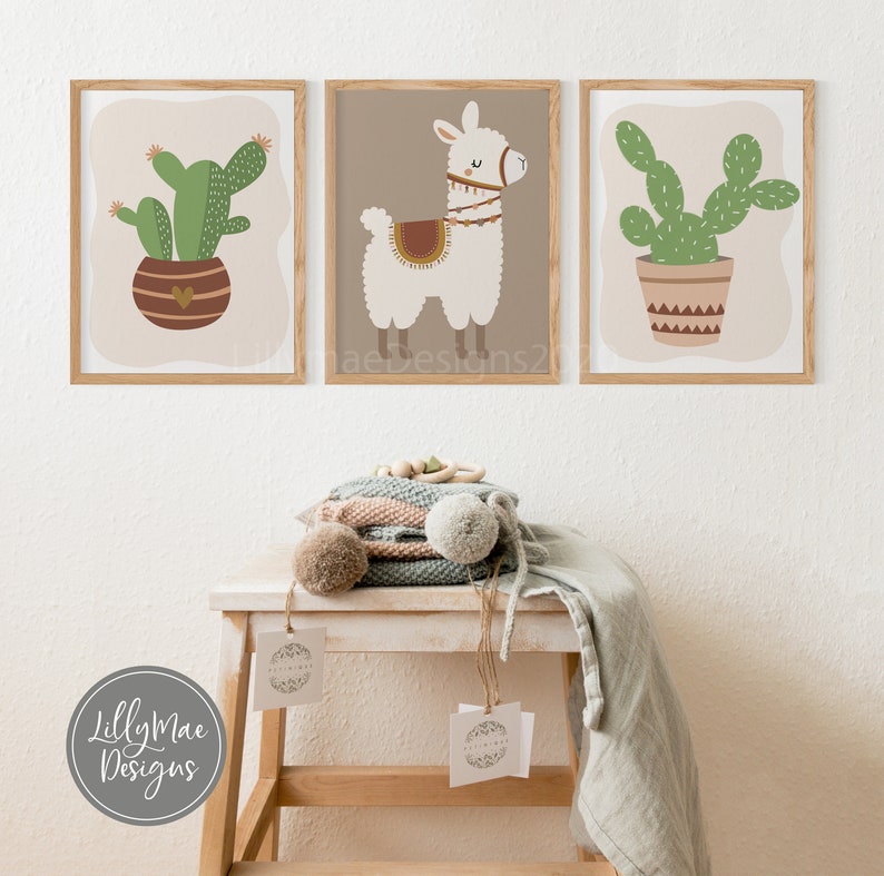 May include: Three framed prints with a light brown background. The prints feature a white llama with a brown saddle, a green cactus in a brown pot with geometric patterns, and a green cactus in a brown pot with a heart design.