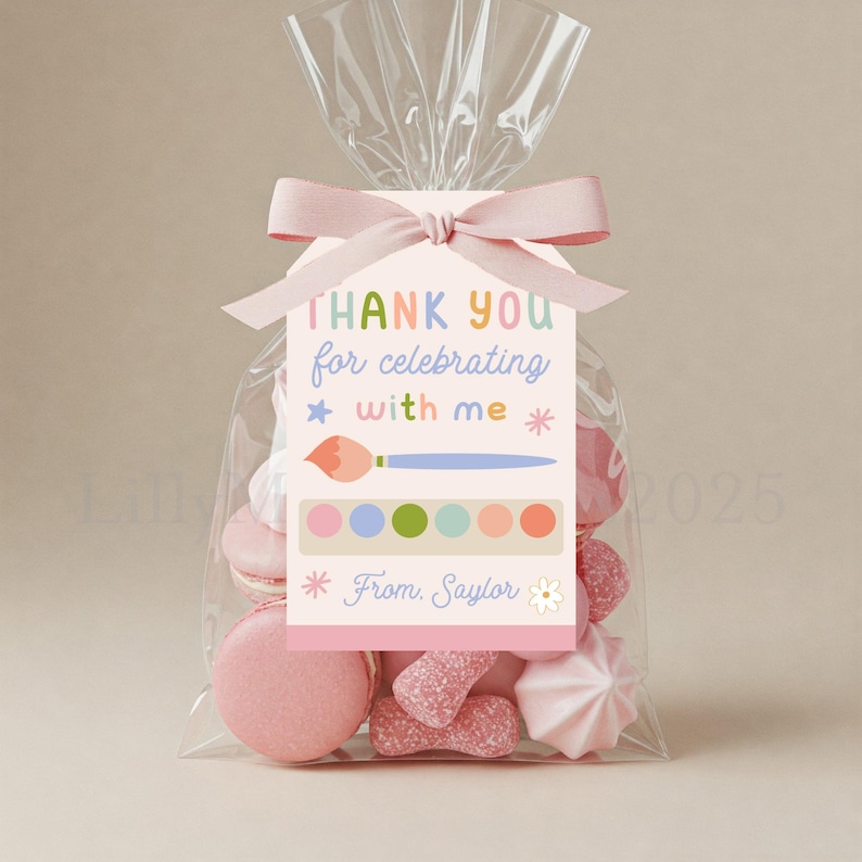 May include: A clear cellophane bag tied with a pink ribbon, filled with pink treats. A pink tag reads "THANK YOU for celebrating with me" with a paintbrush and paint palette graphic. The tag also says "From Saylor".