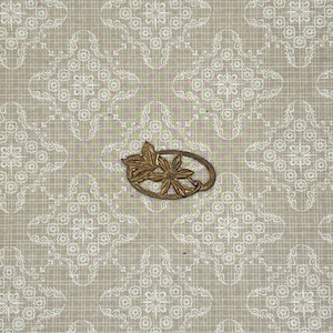 May include: A gold-toned metal floral brooch with an oval frame, featuring a leaf and flower design. The brooch is set against a beige background with a white floral pattern.
