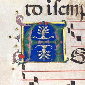 May include: A page from a medieval manuscript with ornate calligraphy and musical notation. The illuminated initial letter "A" is in blue, green, and gold, with floral and foliate designs. The text "to ifany" is visible at the top.