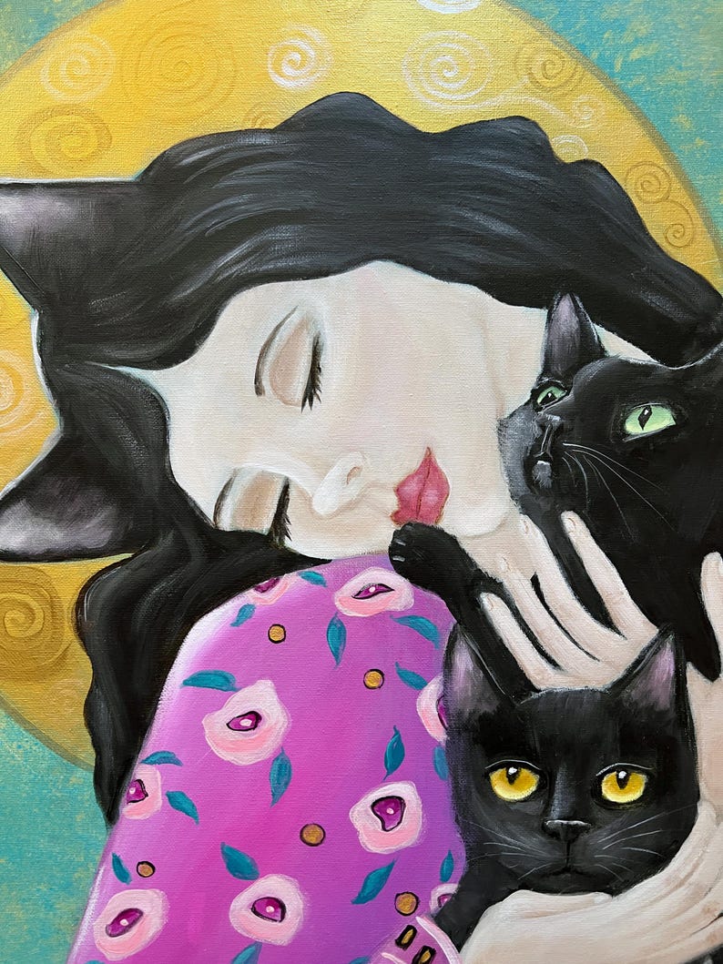 May include: An original painting of a woman with black hair and cat ears, embracing two black cats. The woman wears a pink dress with a floral pattern. The background features a yellow circle and blue accents.