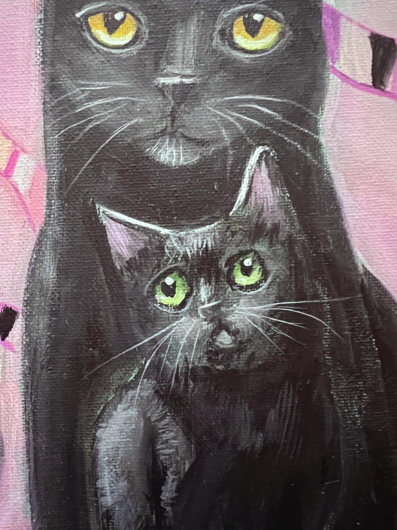 May include: A close-up painting of two black cats. The larger cat has yellow eyes, and the smaller cat has green eyes. The background is a soft pink with hints of purple and white.