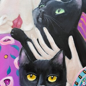 May include: An oil painting featuring two black cats with yellow and green eyes. The cats are set against a background of a person's face and a purple floral pattern. The painting has a whimsical and artistic style.