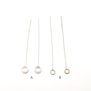 May include: Four silver-colored earring posts with circular loops at the bottom. Two posts have a simple loop design, while the other two have a twisted loop. The posts are labeled A and B.