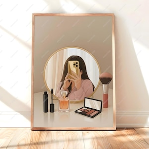 May include: A framed illustration depicts a person taking a selfie in a round mirror. Makeup items, including mascara, perfume, a brush, and an eyeshadow palette, are arranged on a white surface. The frame is a light brown color.