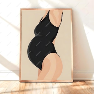 May include: A framed art print featuring a minimalist illustration of a pregnant person in a black swimsuit. The artwork has a beige background and is set in a wooden frame, creating a modern and elegant aesthetic.
