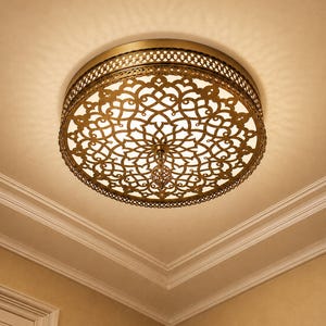 May include: A round flush mount ceiling light fixture featuring an antique brass finish frame with an intricate, laser-cut metal lattice pattern. The design includes a central decorative finial and a white diffuser that emits a warm glow.