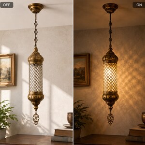 May include: A cylindrical pendant light with an antique brass finish and a clear glass lattice shade. The fixture features a decorative metal finial at the bottom and is suspended by a matching brass chain. The light is shown in both off and on states.