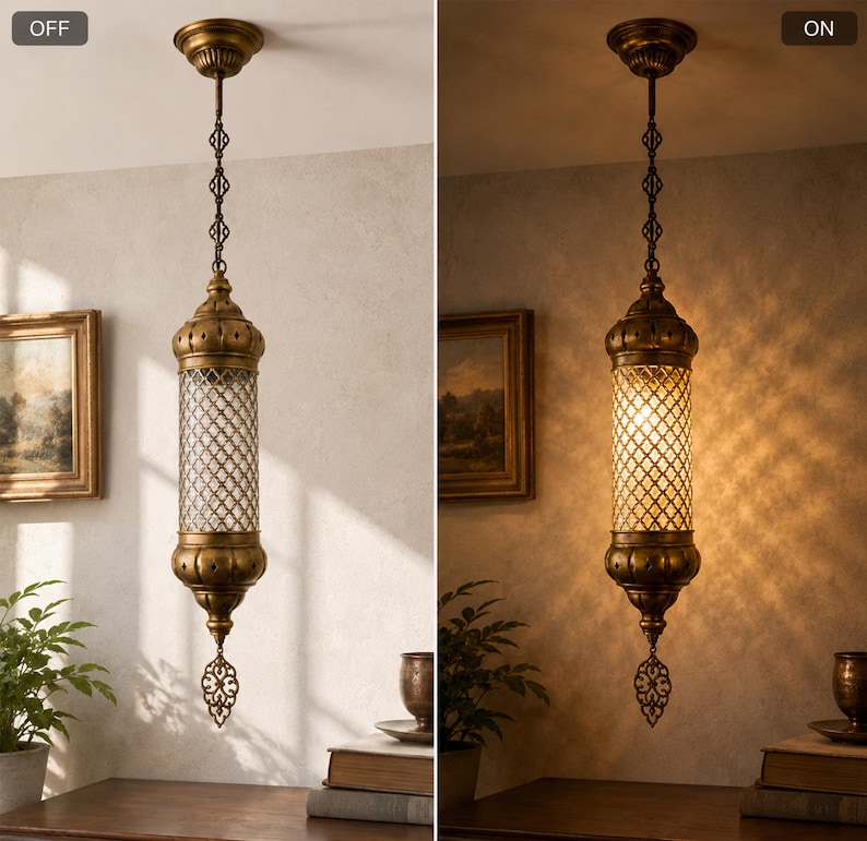 May include: A cylindrical pendant light with an antique brass finish and a clear glass lattice shade. The fixture features a decorative metal finial at the bottom and is suspended by a matching brass chain. The light is shown in both off and on states.