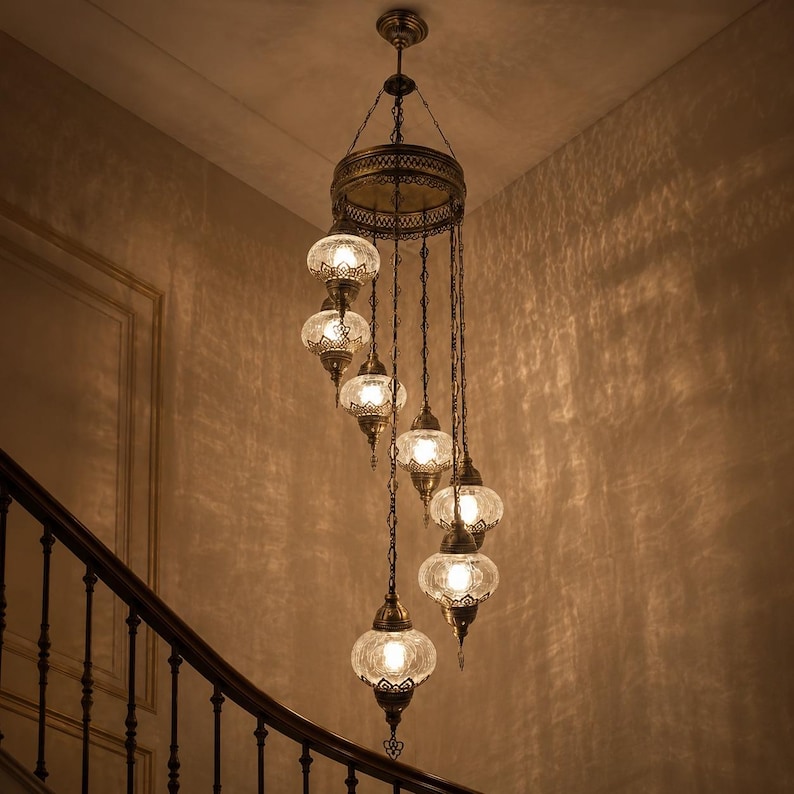 May include: An ornate, antique-style chandelier with multiple glass globes. The fixture is suspended from the ceiling by chains and features a decorative metal frame. The glass globes have a textured pattern, and the overall color scheme is warm.