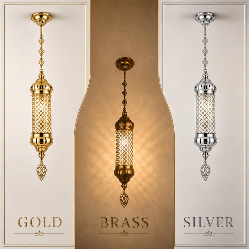 May include: Three cylindrical pendant lights hanging vertically. The left light is gold, the center is brass, and the right is silver. Each features a decorative metal lattice shade, a circular ceiling mount, and a filigree finial at the bottom.