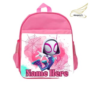 May include: Pink backpack featuring a Spider-Gwen graphic with a pink and white spiderweb design. The backpack has a top handle, side pockets, and the text "Name Here" on the front. The backpack is designed for children.