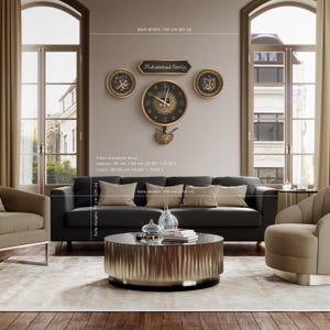 May include: A living room with a black sofa, beige cushions, and a round coffee table. Above the sofa, a wall clock and decorative pieces with Arabic script and the text "Mohammed Family" are displayed. The clock is approximately 50 cm in diameter.