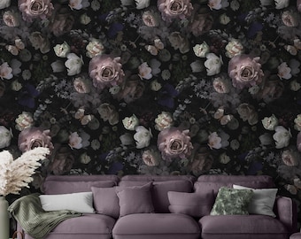 May include: A dark floral wallpaper with a repeating pattern of pink roses, white flowers, and green leaves on a black background. The wallpaper is shown in a living room setting with a purple sofa and throw pillows.