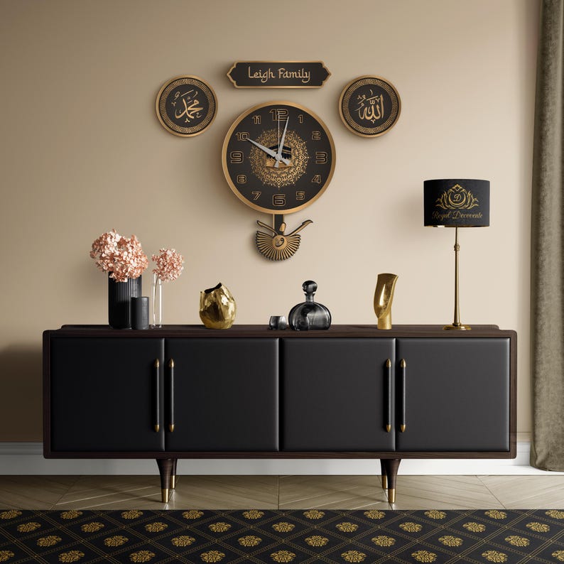 May include: A black and gold wall clock with a decorative pendulum hangs above a black cabinet. The clock is surrounded by gold-framed wall art and a lamp. The cabinet has gold handles and legs. The rug has a gold pattern.