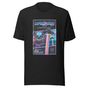 May include: Black t-shirt with a retro video game graphic. The graphic features a skull, a spaceship, and the text "Coping Soon 1978 - Invaders From Space - Play at Arcade".