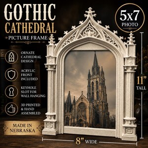 May include: A cream-colored picture frame with an ornate gothic cathedral design, featuring an acrylic front and a keyhole slot for wall hanging. The frame holds a 5x7 photo, measures 11 inches tall and 8 inches wide, and is 3D printed.