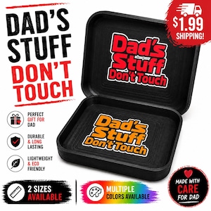 May include: Black rectangular tray with rounded corners, featuring the text "DAD'S STUFF DON'T TOUCH" in red and white. The tray is open, revealing the same text inside. The product is advertised as a gift for dad.
