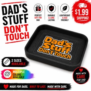 May include: A black tray with the text "Dad's Stuff Don't Touch" in orange and white. The tray has a square shape with rounded corners. The image also includes text that says "Made for Dads. Built to Last. Made with Care."