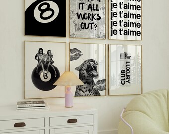 May include: A collection of framed art prints with gold frames. The prints feature an 8-ball, text that reads "WHAT IF IT ALL WORKS OUT?", "je t'aime", a photo of two women, a leopard, and the words "CLUB LUXURY".