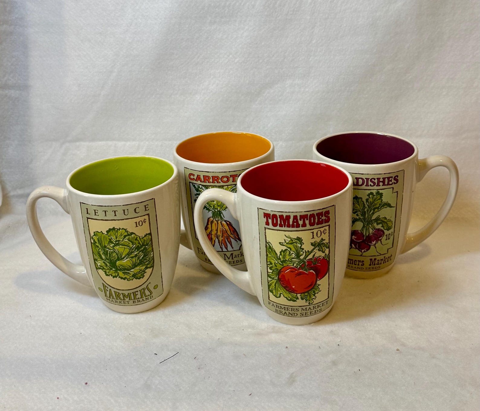 Set of four mugs from the "Farmers Market" collection produced by Signature Housewares Inc.