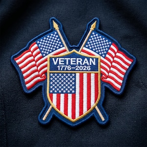 May include: Embroidered patch featuring the American flag and the word "VETERAN" with the years 1776-2026. The patch has a blue border and is set against a dark blue background. The flags are red, white, and blue.