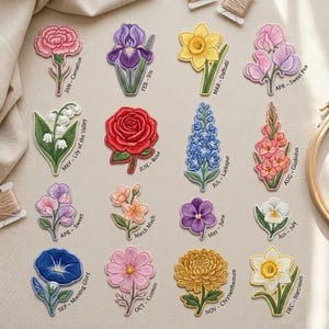 May include: Embroidered floral patches featuring various flowers, each labeled with a month and flower name. Includes a pink carnation, purple iris, yellow daffodil, pink sweet pea, white lily of the valley, red rose, blue larkspur, and more.