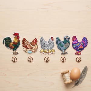 May include: Five embroidered iron-on patches featuring poultry designs labeled one through five. The patches depict a colorful rooster, a brown hen with an egg, a grey hen with four chicks, a blue-grey hen, and a vibrant purple and pink hen.
