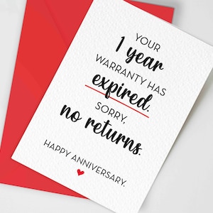 May include: A white greeting card with black text that reads: YOUR 1 year WARRANTY HAS expired. SORRY, no returns. HAPPY ANNIVERSARY. A red line is drawn through the word expired and a small red heart is below the text. A red envelope is behind it.