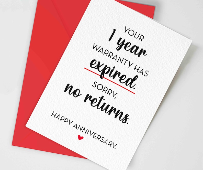 May include: A white greeting card with black text that reads: YOUR 1 year WARRANTY HAS expired. SORRY, no returns. HAPPY ANNIVERSARY. A red line is drawn through the word expired and a small red heart is below the text. A red envelope is behind it.