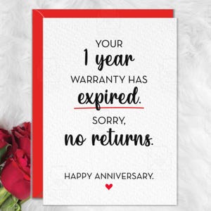 May include: A white greeting card with a red envelope border featuring black text that reads: YOUR 1 year WARRANTY HAS expired. SORRY, no returns. HAPPY ANNIVERSARY. A small red heart is printed below the text, and red roses are visible on the left.