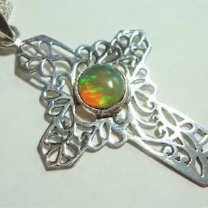 Opal Cross Pendant is a Best Quality Solid Round Opal with Fire, in a Sterling Cut Filigree Cross, on an 18&quot; Solid Sterling Box Chain