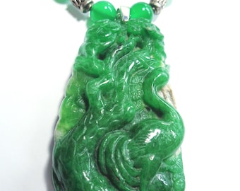 May include: A green jade pendant necklace with a carved dragon design. The necklace is made of green jade beads and silver metal beads.