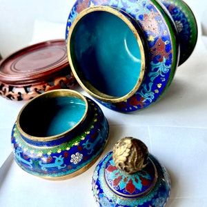 May include: A set of three blue and gold cloisonn&eacute; Chinese incense burners with floral and animal designs. The lid of the burner has a gold finial.