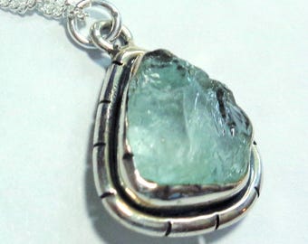 Raw Aquamarine Pendant has a Natural Clear Aquamarine Gem Nugget in a Sterling Setting, on an 16" Sterling Silver Chain