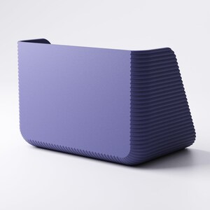 May include: A modern, rectangular planter in a muted purple hue. The planter has a smooth front and a textured, ridged design on the sides, creating a contrast in texture. The overall shape is slightly trapezoidal, with a small lip at the top.