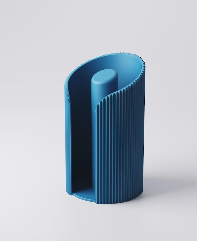 May include: A contemporary blue paper towel holder with a distinctive, curved form. The holder has vertical ridges on the outside and a central, cylindrical post. The overall shape is a stylized, open cylinder, suitable for a modern kitchen.