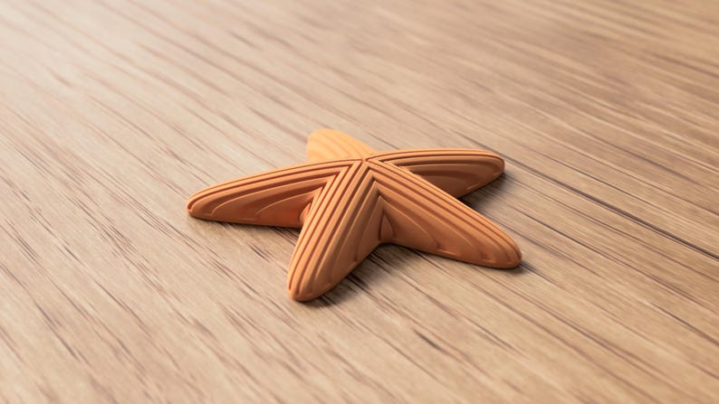 May include: A light brown, five-pointed starfish with textured ridges, resting on a wooden surface. The starfish is a decorative item, possibly for home decor or coastal-themed crafts.
