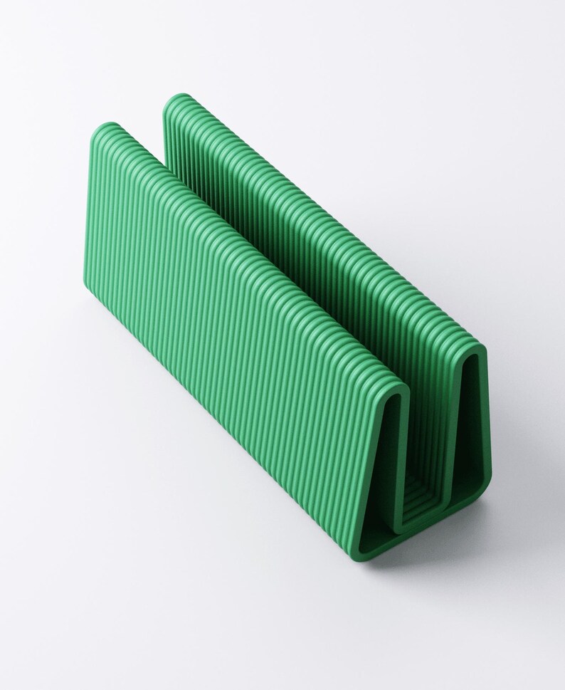 May include: A vibrant green, U-shaped object with a ribbed texture. The design features two parallel, vertical sections connected by a curved base. The object is made of a solid material and is set against a white background.
