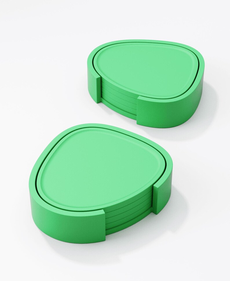 May include: Two sets of green coasters. Each set includes a stack of coasters with a rounded triangular shape and a matching holder. The coasters and holders are a solid, bright green colour, and are set against a white background.
