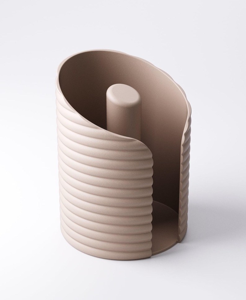 May include: A beige, modern toilet paper holder. The holder has a cylindrical shape with a ridged exterior and a central, vertical post. The design is minimalist and functional, suitable for a contemporary bathroom.