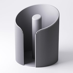 May include: A contemporary grey paper towel holder. It features a central cylindrical post and a curved, ridged outer design. The minimalist aesthetic emphasises form and function. The holder is constructed from a solid, matte material.